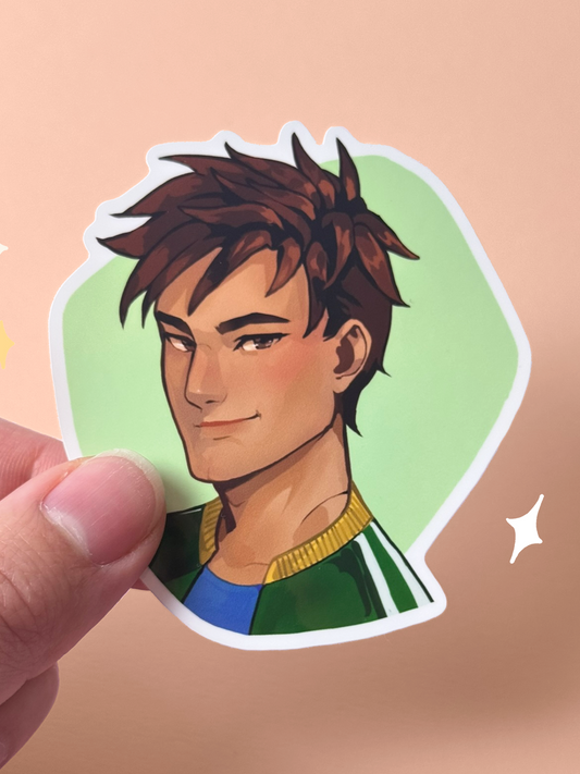 Die-cut vinyl sticker of Alex from Stardew Valley, with spiky brown hair, brown eyes, and a green and gold letterman-style jacket over a blue shirt, smiling confidently on a green background, held between fingers against a peach background.