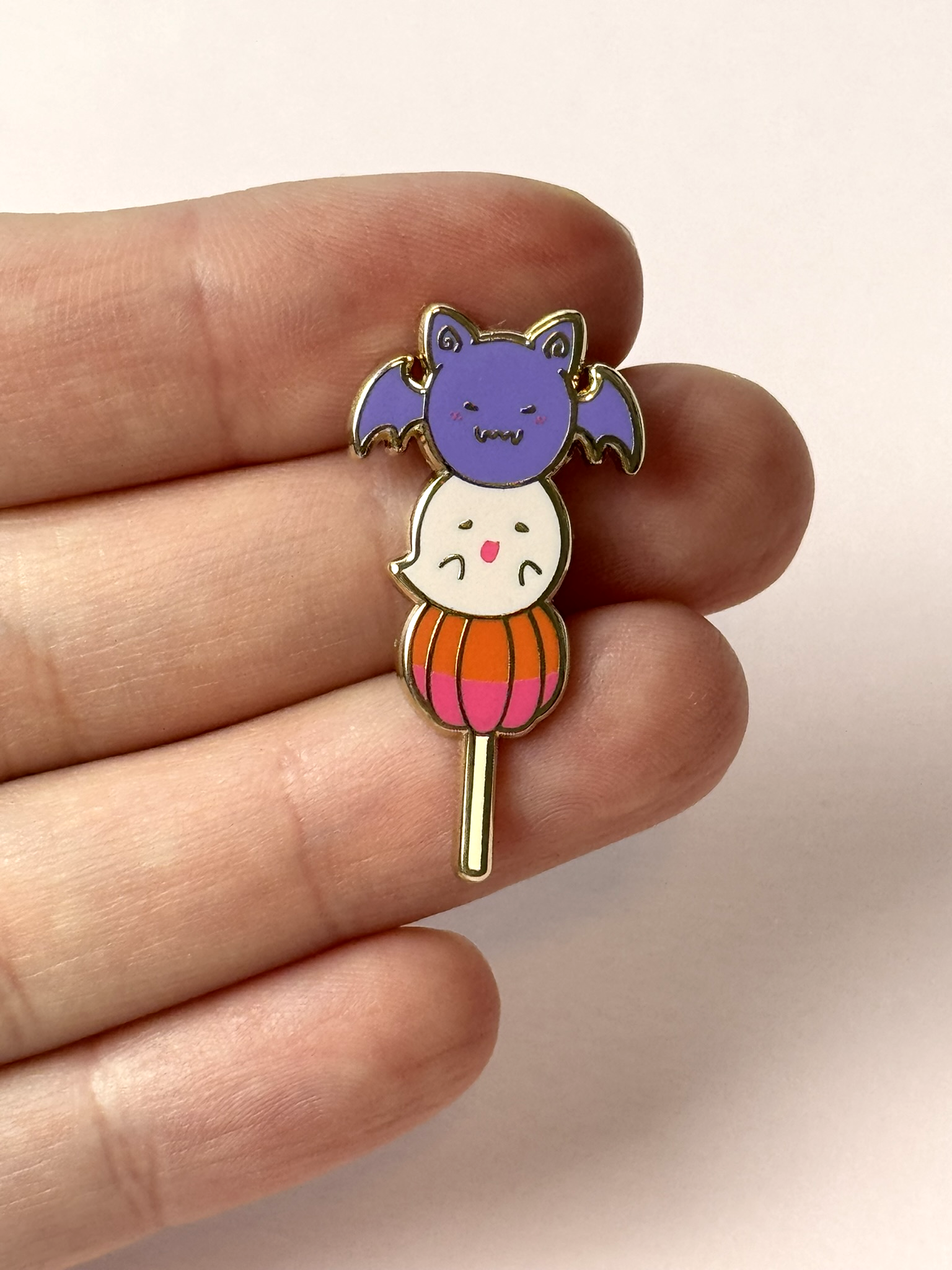 The Halloween mochi pin held in hand