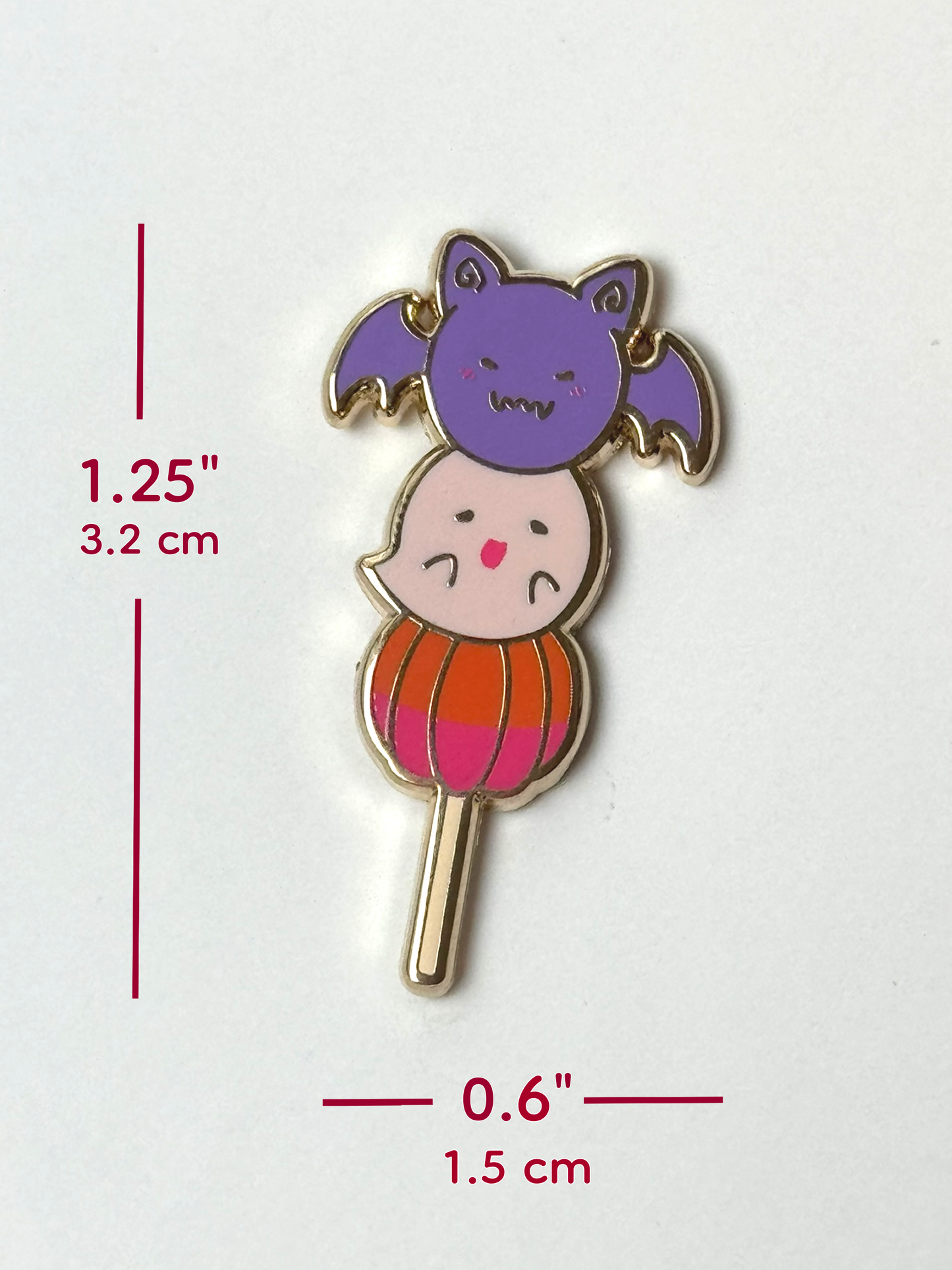 The Halloween mochi pin measures 1.25 inches tall and 0.6 inches wide.