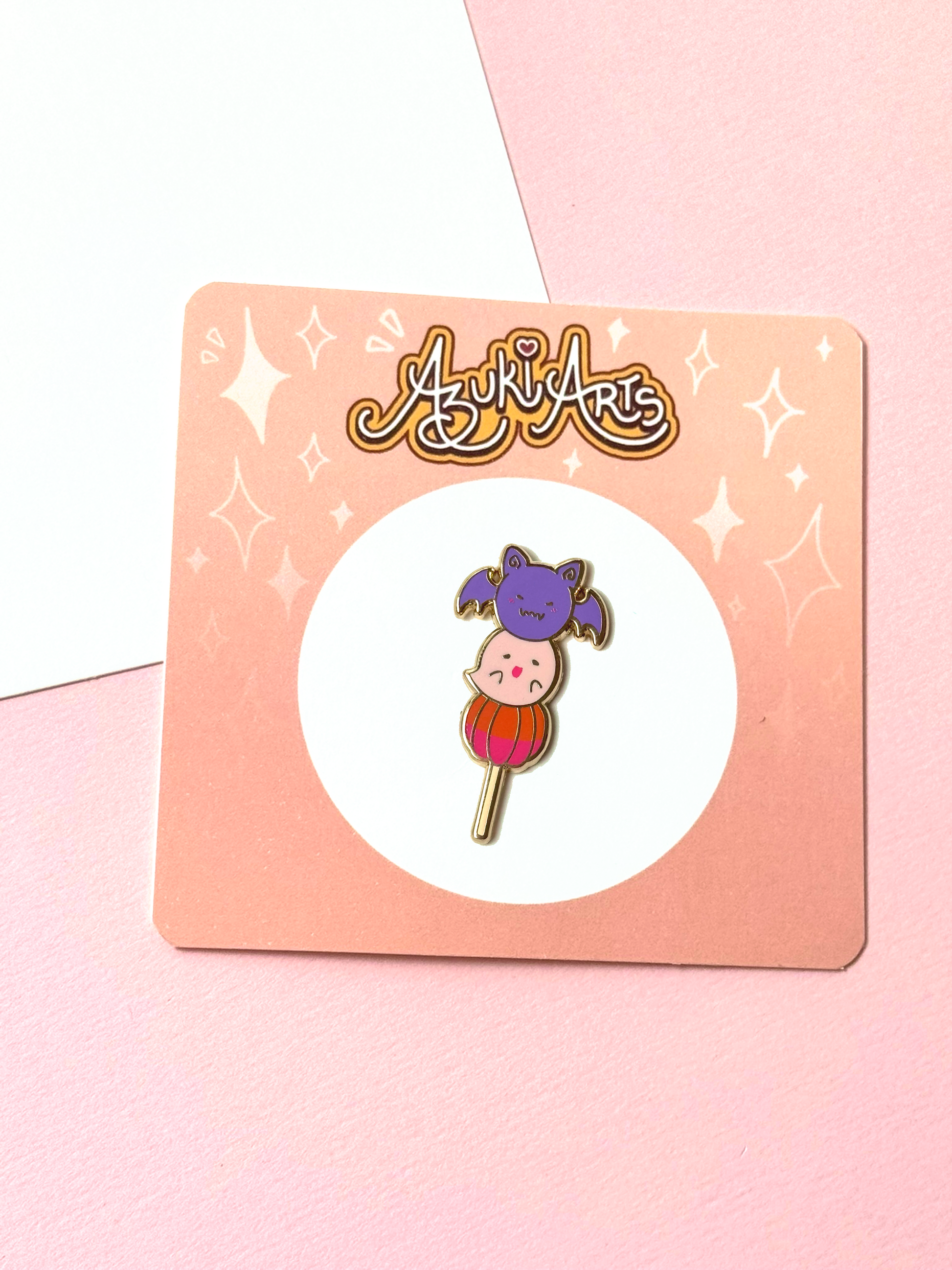The Halloween mochi pin with its backing card