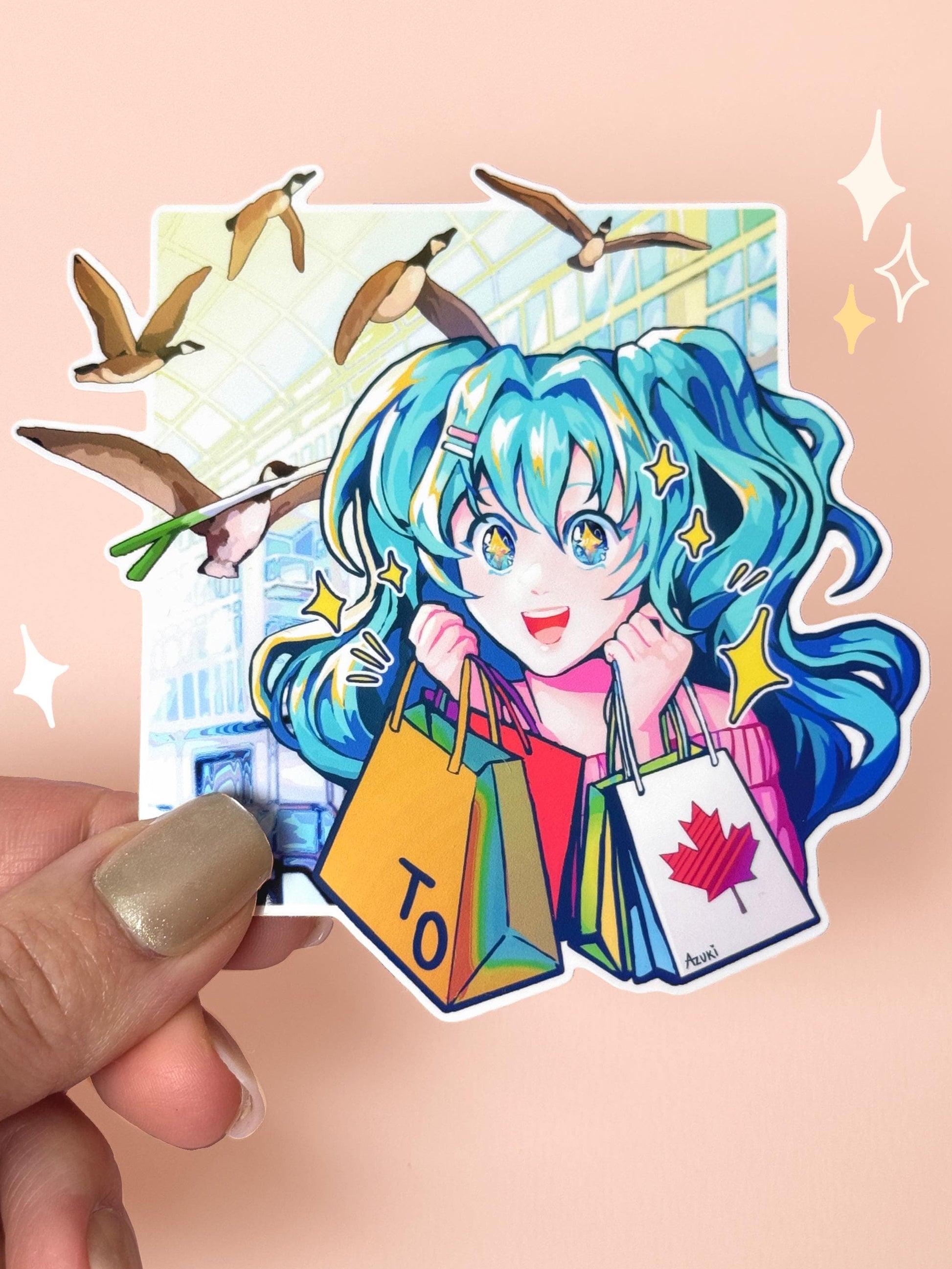 Die-cut vinyl sticker of Hatsune Miku shopping at Toronto's Eaton Centre — turquoise twintails with stars in her eyes, holding shopping bags with the Toronto "TO" logo and a Canadian maple leaf, with Canada geese flying overhead (one snatching her iconic leek), held between fingers against a peach background.