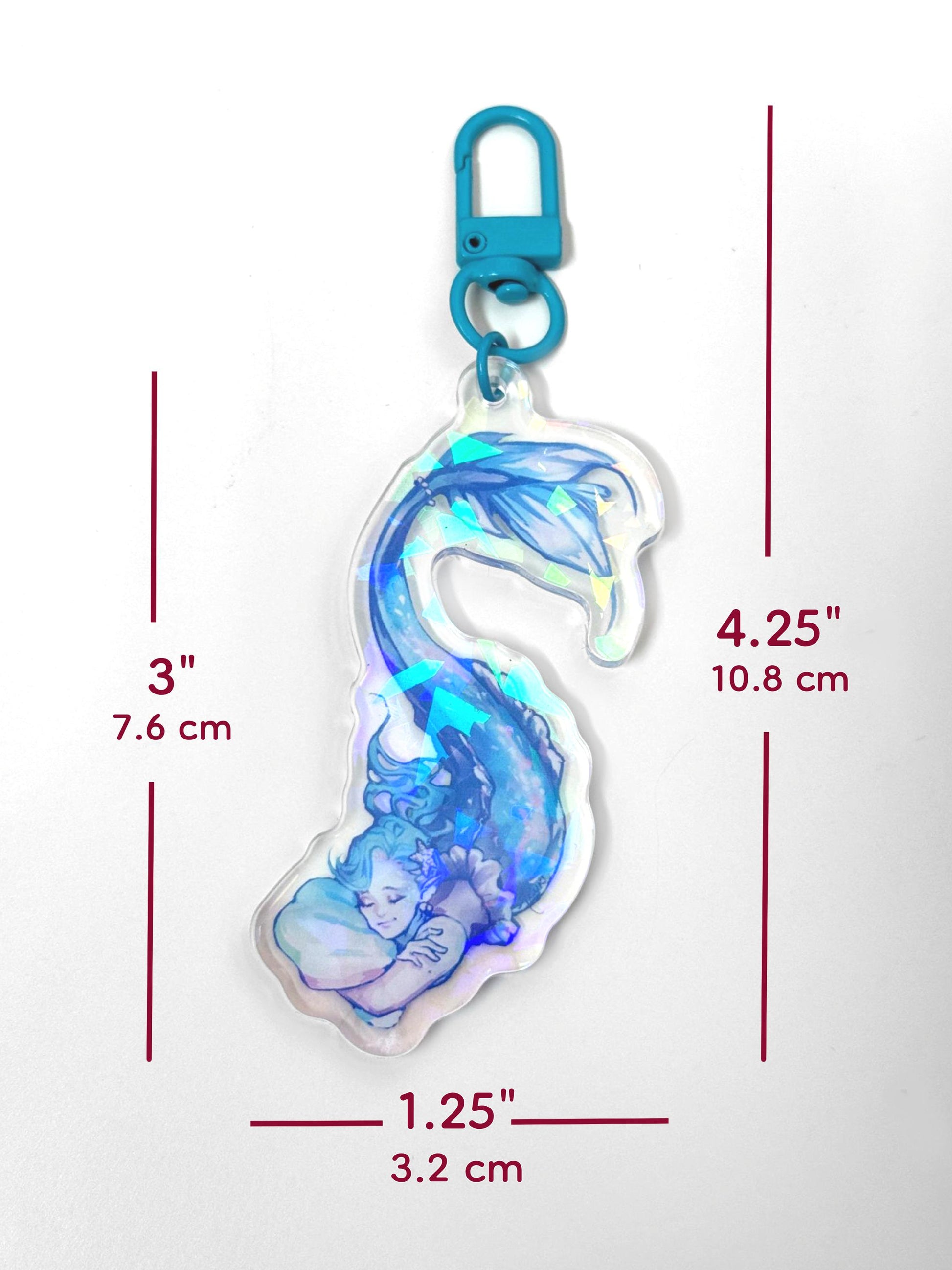 The holographic mermaid keychain measures 3 inches tall and 1.25 inches wide. Including the clasp, the entire keychain is 4.25 inches tall.