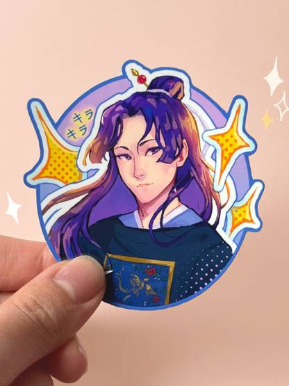 Die-cut vinyl sticker of Jinshi from The Apothecary Diaries, with long purple hair in a half-bun held by a red-gemmed hairpin, wearing a navy embroidered Chinese-style robe with gold floral detail, surrounded by yellow sparkle stars and "kira kira" katakana, on a purple oval background, held between fingers against a peach background.