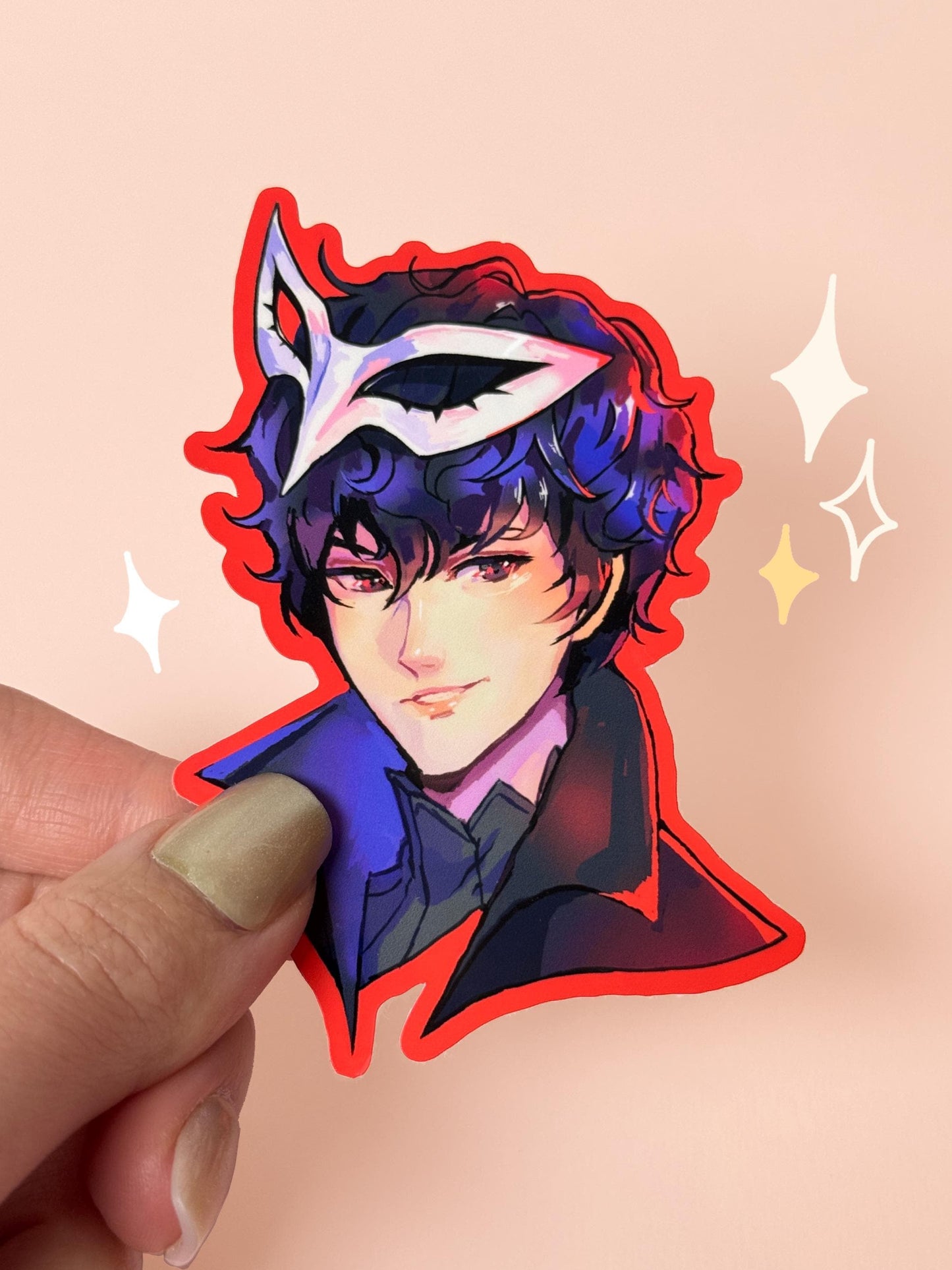 Die-cut vinyl sticker of Joker from Persona 5 wearing his white Phantom Thief mask, outlined with a bold red border, held between fingers against a peach background.