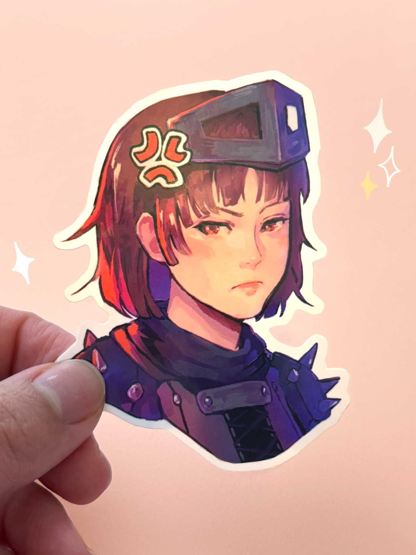 Die-cut vinyl sticker of Makoto Niijima (Queen) from Persona 5 Royal, wearing her Phantom Thief armor and metal visor pushed up over short brown hair, with a serious expression, held between fingers against a peach background.