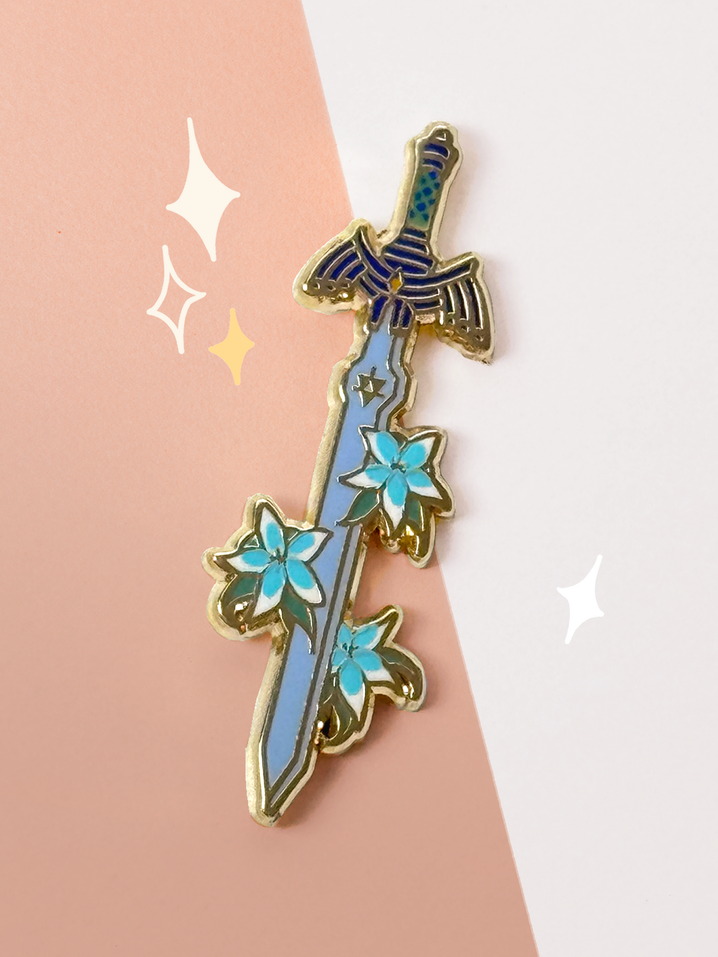 Gold-lined hard enamel pin of the Master Sword from The Legend of Zelda, blade pointing down through pale blue Silent Princess flowers, on a peach and white background.