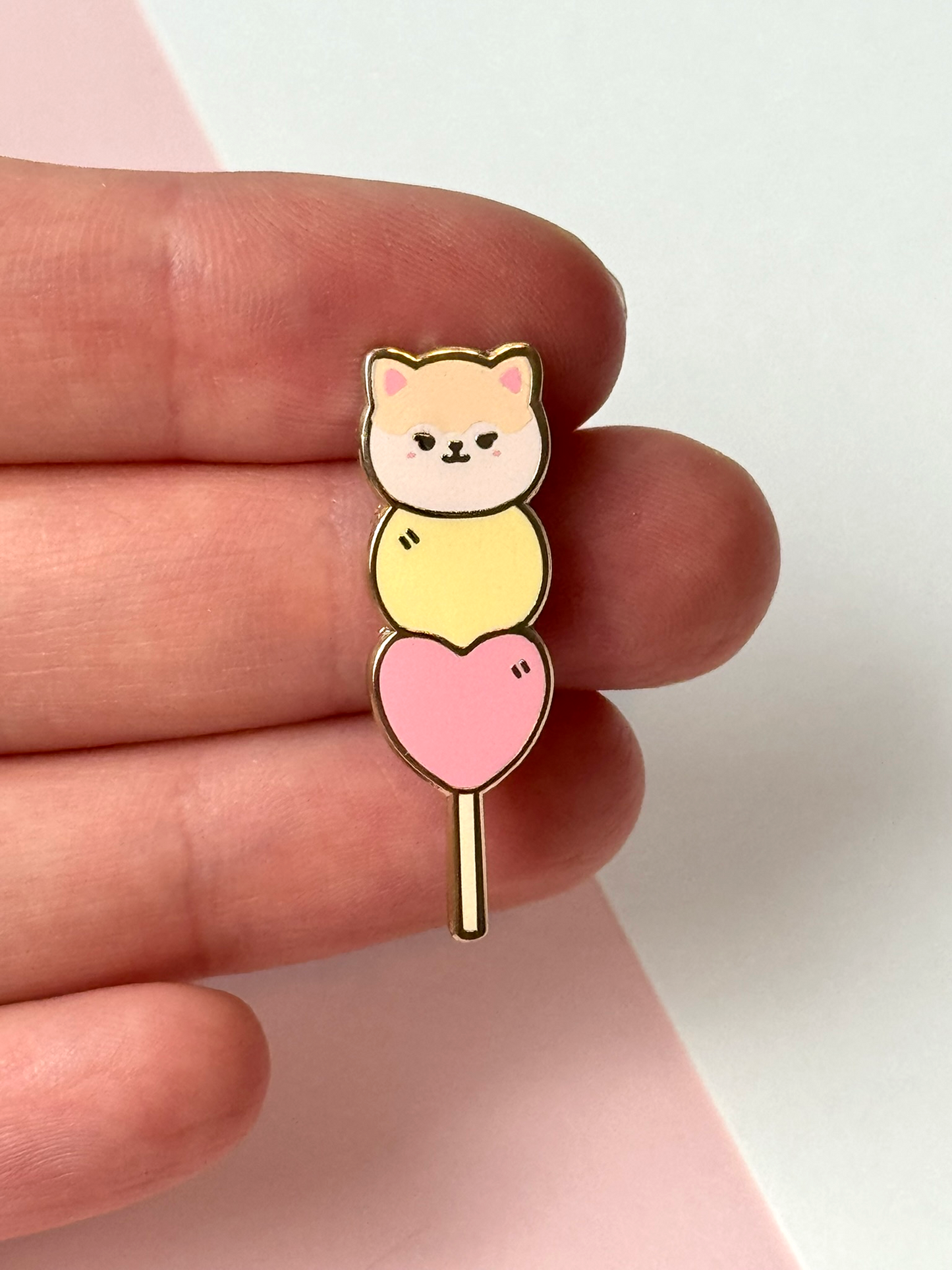 The May mochi pin shown held in hand.
