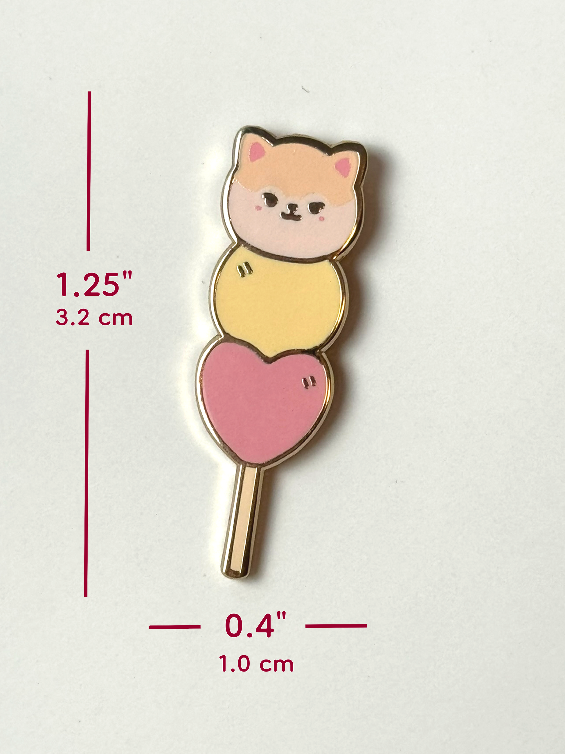 The May mochi pin is 1.25 inches tall and 0.4 inches wide.