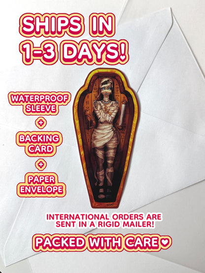 The mummy coffin girl sticker ships in 1 to 3 days in a waterproof sleeve, backing card, and paper envelope.