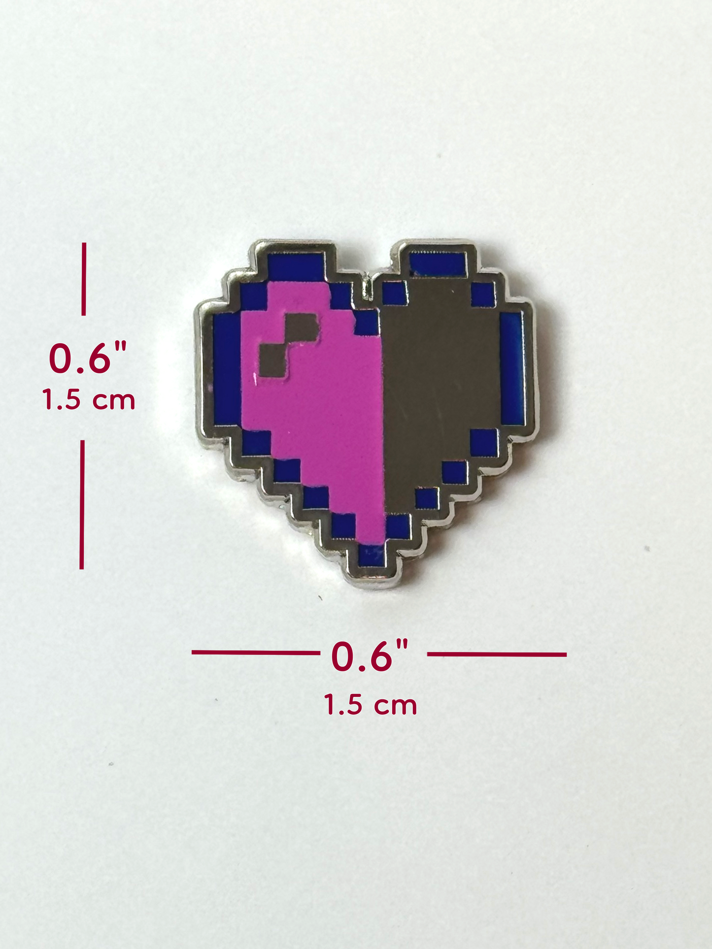 The pixel heart pin measures 0.6 inches tall and 0.6 inches wide.