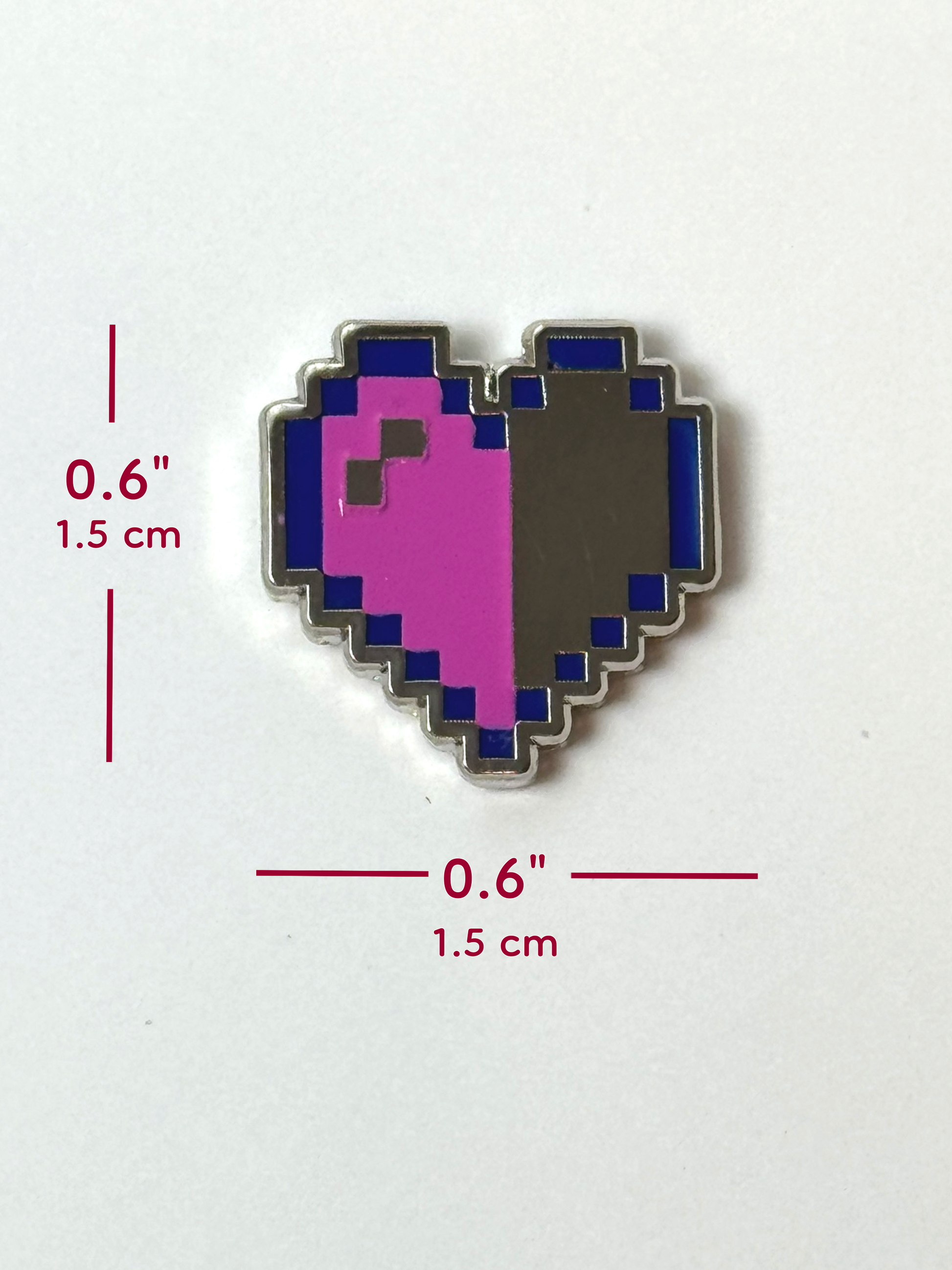The pixel heart pin measures 0.6 inches tall and 0.6 inches wide.