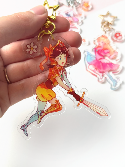 The Princess Daisy keychain held in hand.