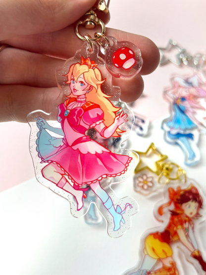 The Princess Peach keychain held in hand