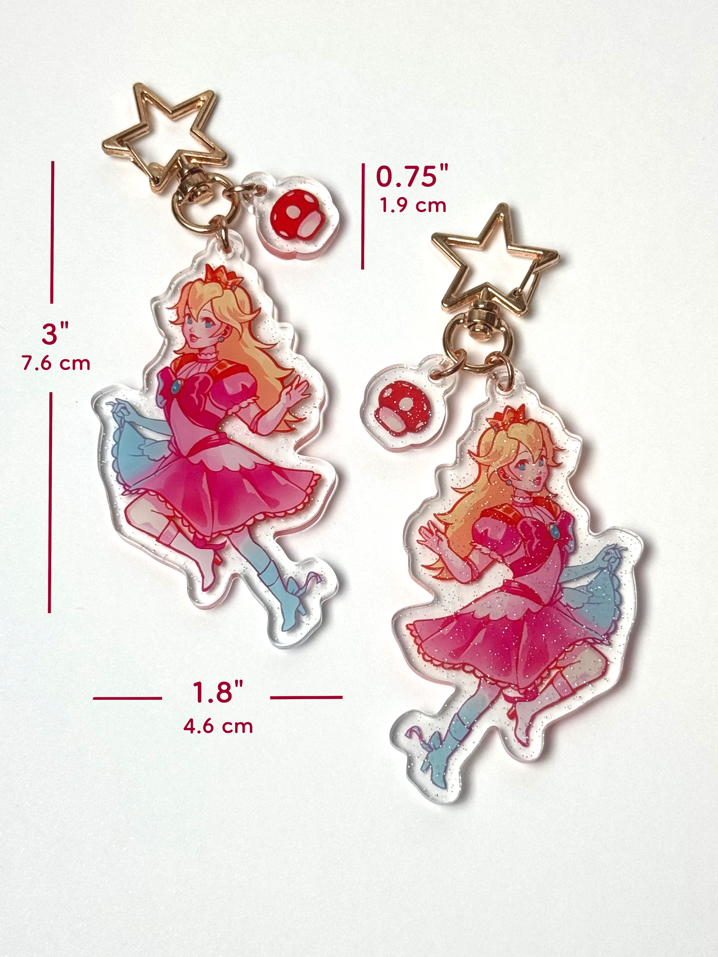 The Princess Peach keychain measures 3 inches tall and 1.8 inches wide. The mini mushroom clasp is 0.75 inches tall.