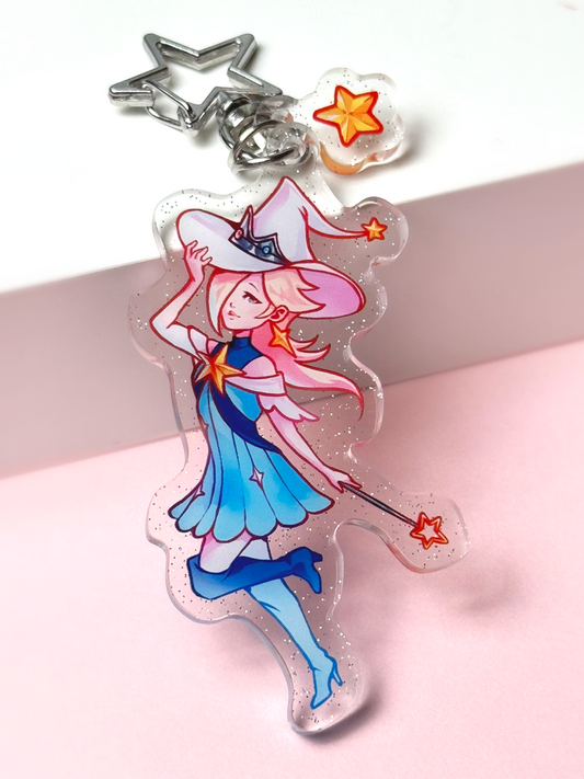 Holographic acrylic keychain of Princess Rosalina from Super Mario reimagined as a mage — pale blonde hair, a blue witch hat and dress, holding a star wand, with a star-shaped clasp and a star charm.