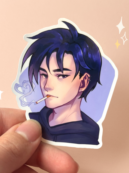 Die-cut vinyl sticker of Sebastian from Stardew Valley, with dark blue hair, an ear piercing, and a black hoodie, a cigarette and curl of smoke at his lips, on a soft purple background, held between fingers against a peach background.