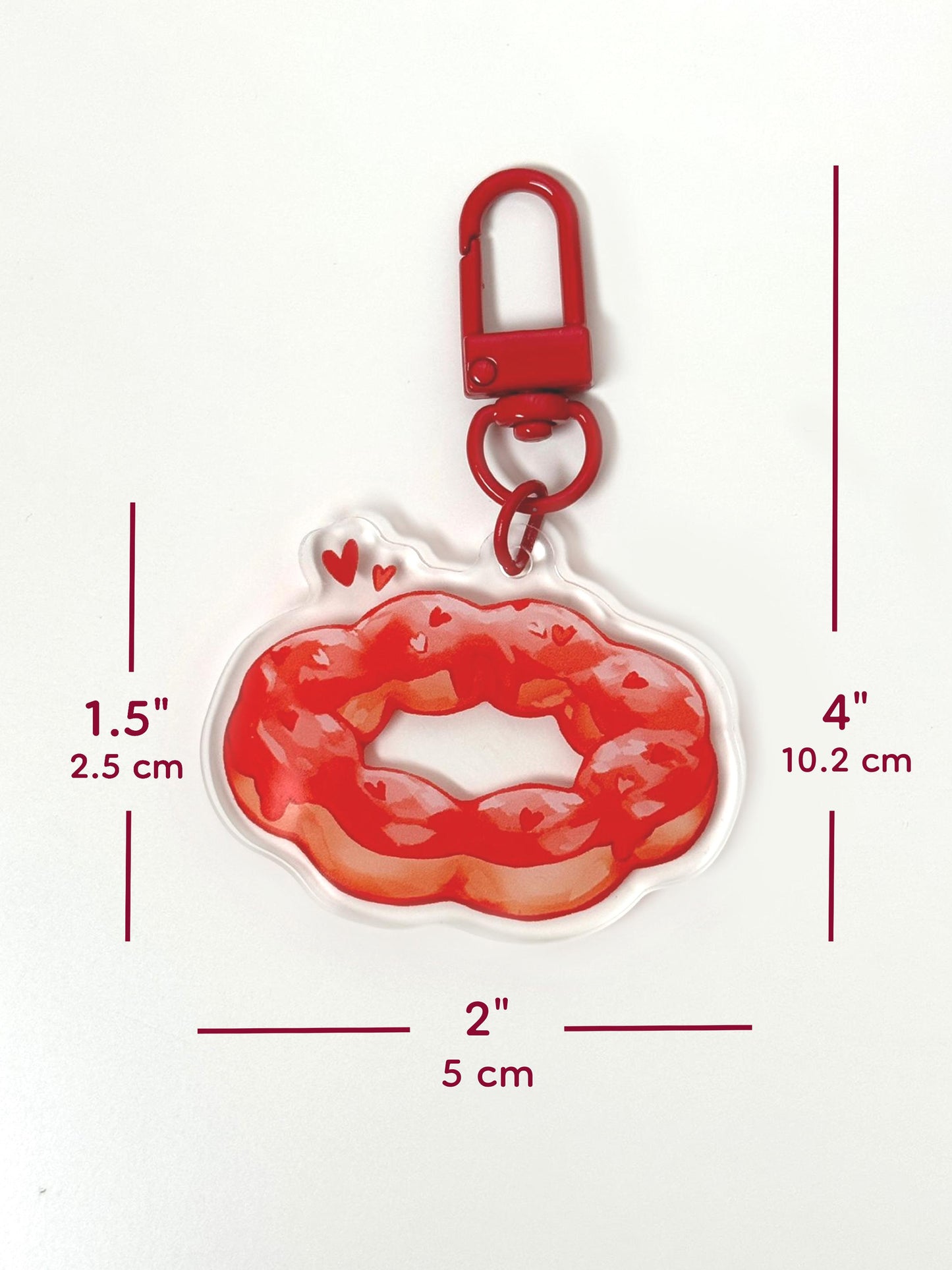 The strawberry mochi donut keychain measures 1.5 inches tall and 2 inches wide. With the clasp, it measures 4 inches tall.