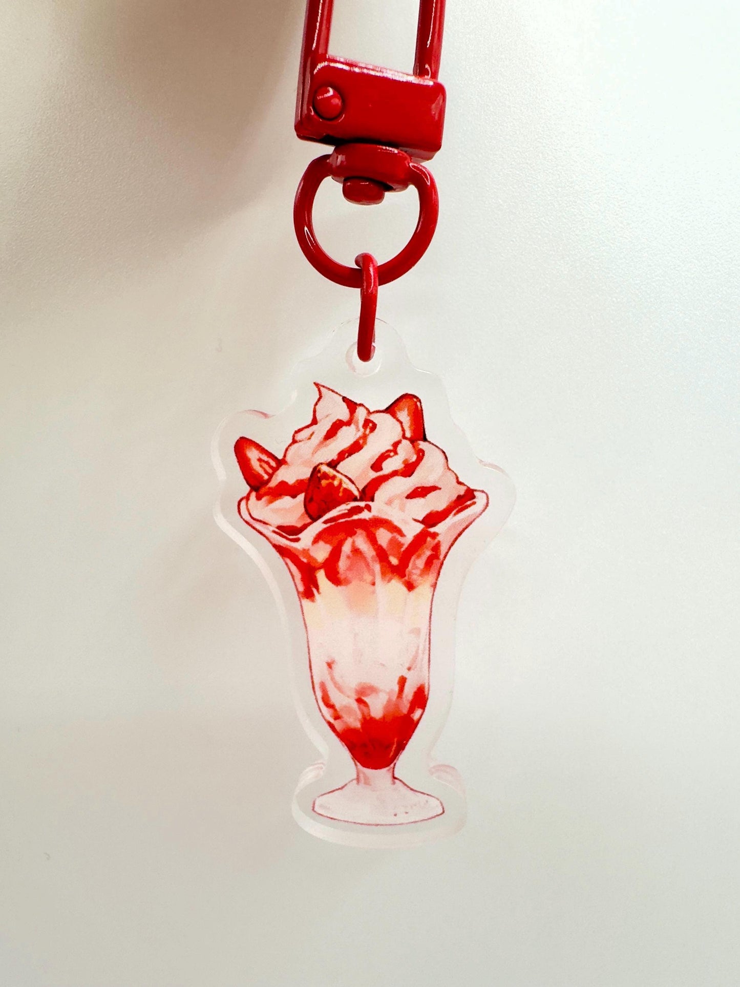 The strawberry parfait keychain against a white background.