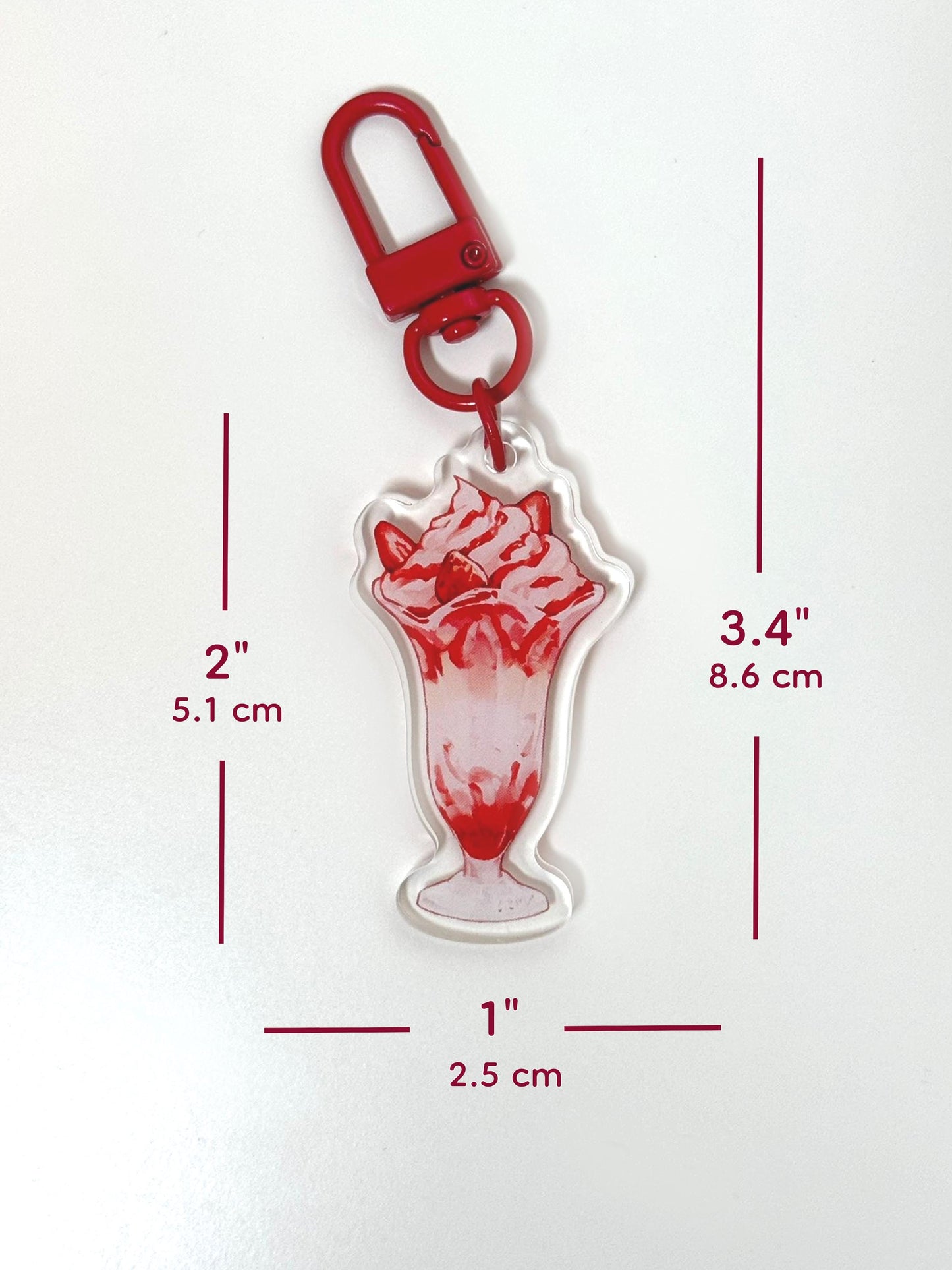 The strawberry parfait keychain measures 2 inches tall and 1 inches wide. With the clasp, it measures 3.4 inches tall.