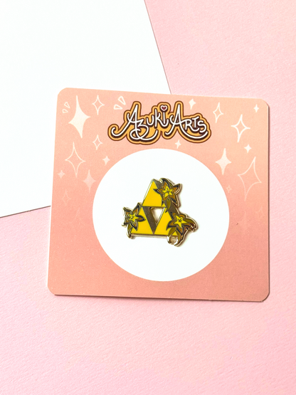 The triforce pin with the backing card.