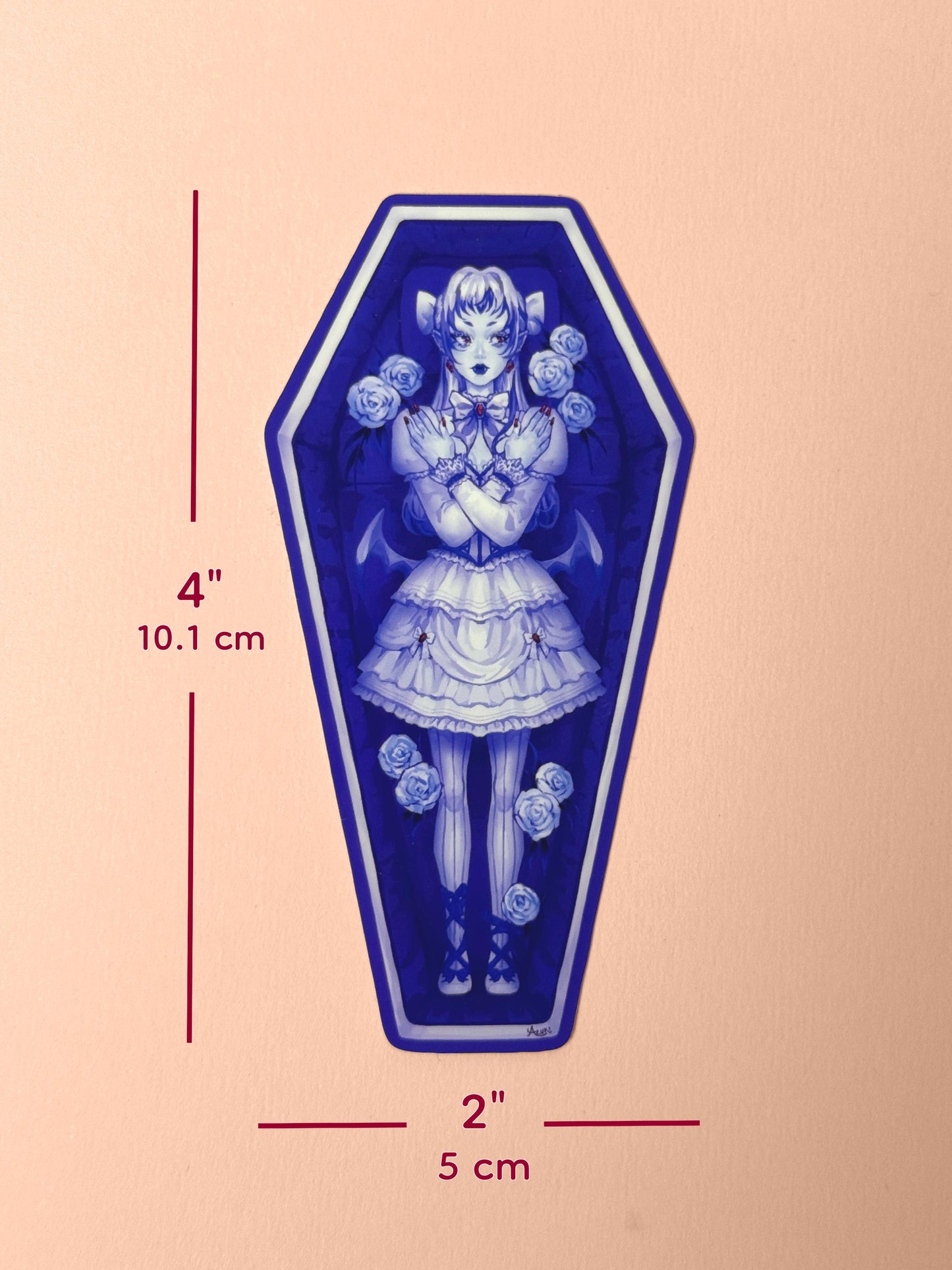 The vampire coffin girl sticker measures 4 inches tall and 2 inches wide.