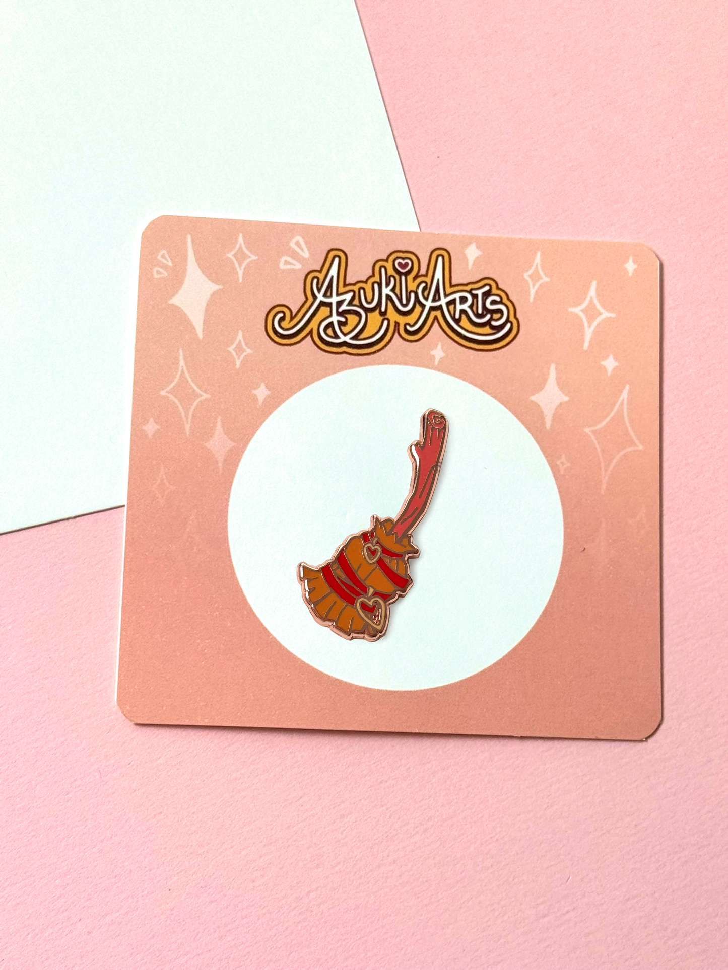 The witch broom pin with its backing card.